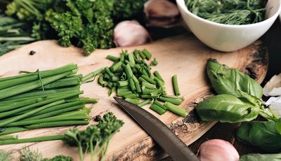 Kräuter und Knoblauch auf einem Schneidebrett